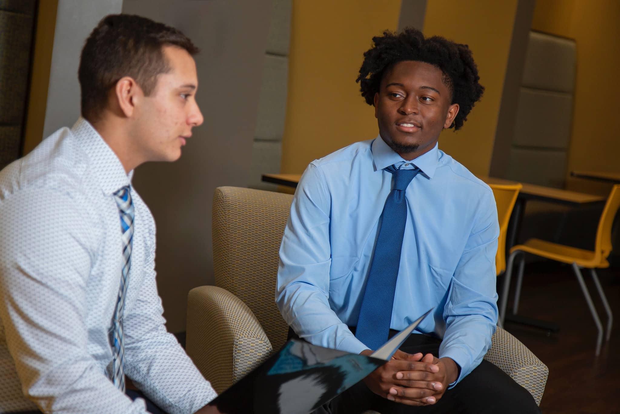 Two male students in business talking in shirt and tie