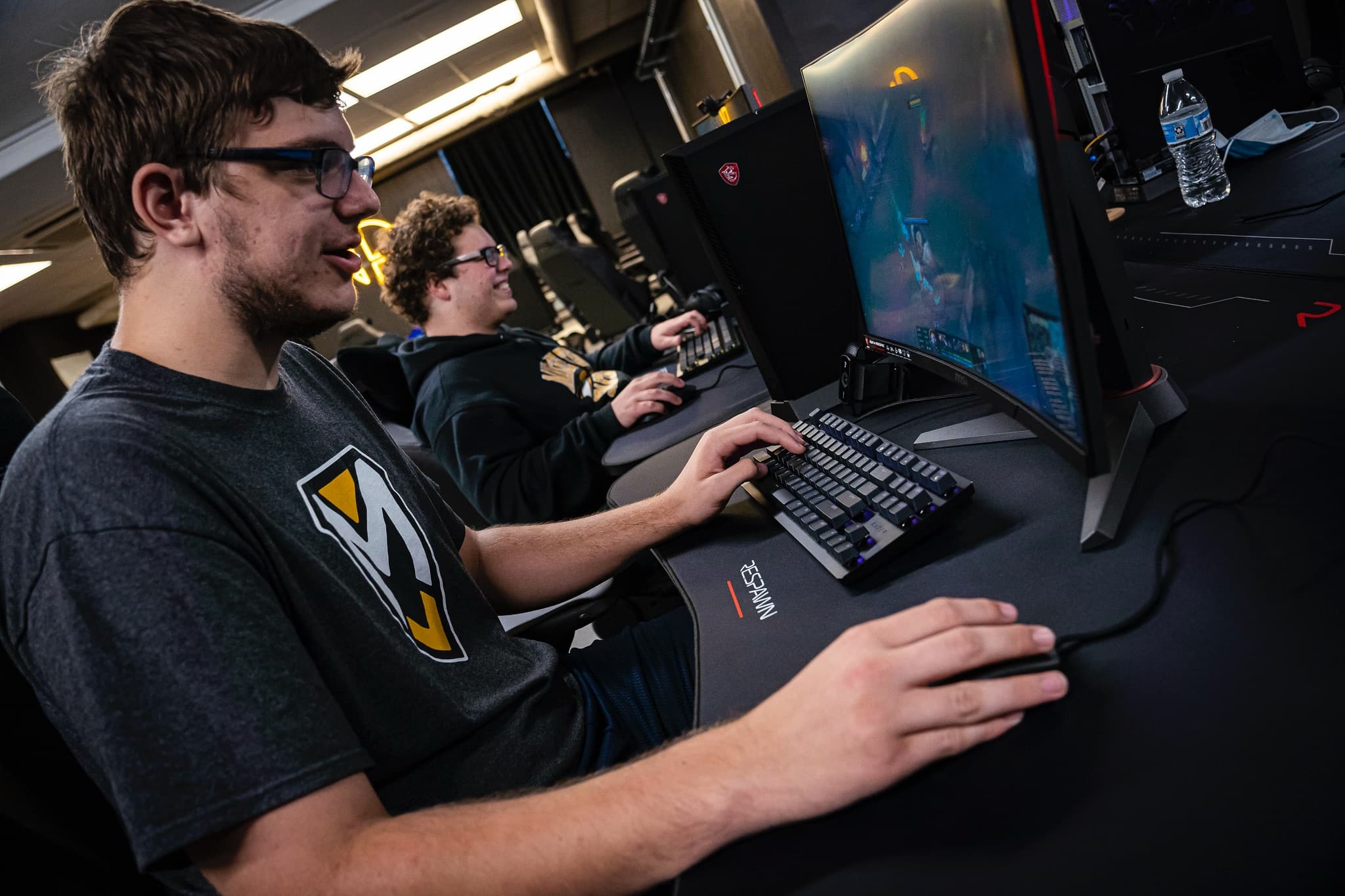 2 students playing computer games in an esports league
