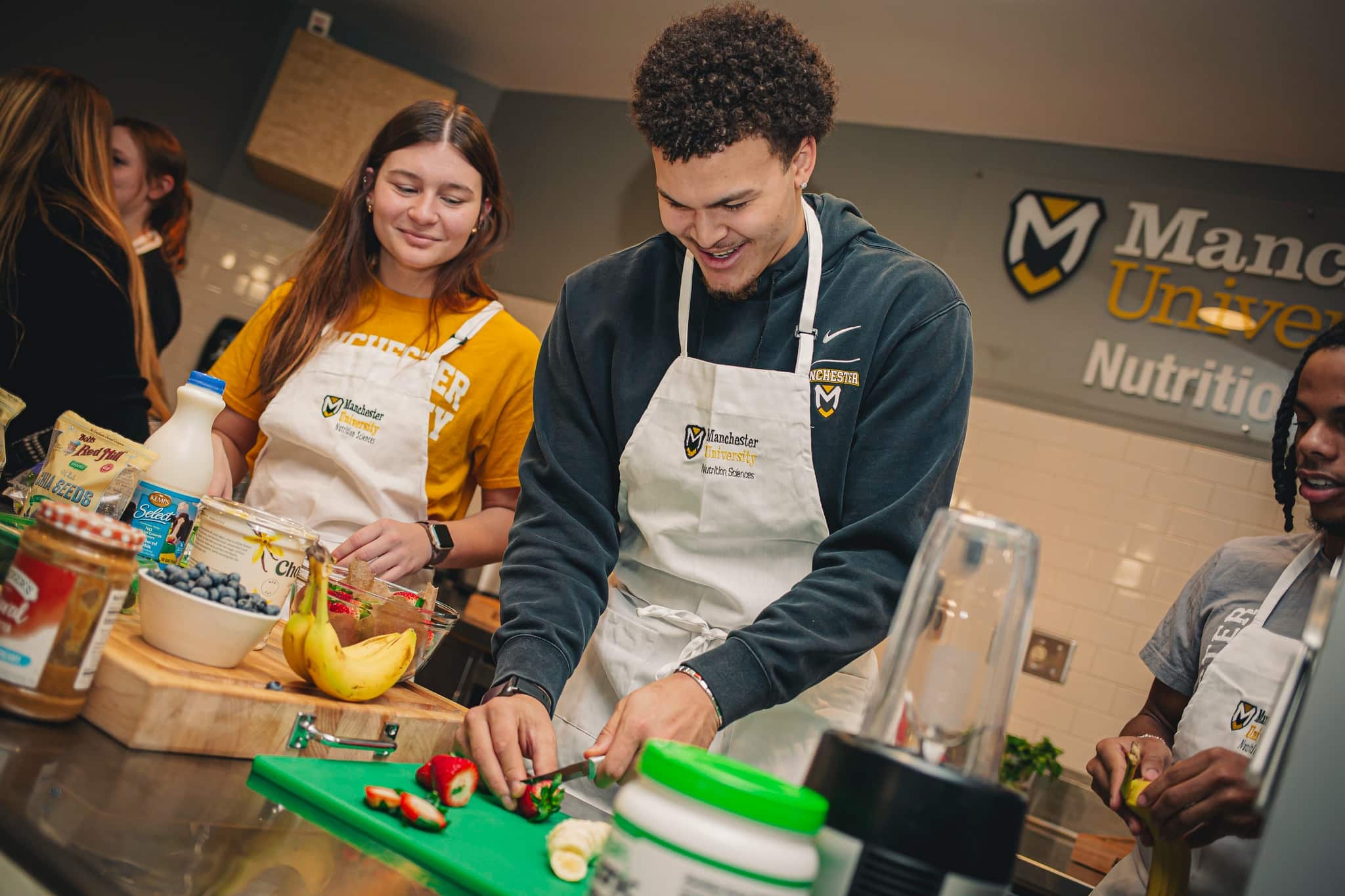 a group of nutrition students prepare a recipe during class