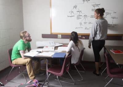students studying at white board