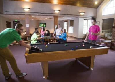 students playing pool in residence hall