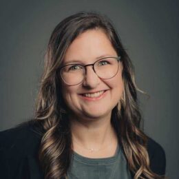 Portrait of Stephanie McCracken wearing thin rimmed glasses.
