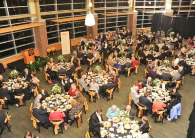 People seated at tables eating a meal at the Haist Commons Gala