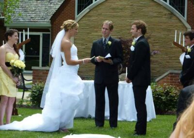 Bride and groom exchange vows at an outdoor wedding ceremony
