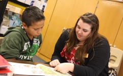 An Education student works one-on-one with a young student