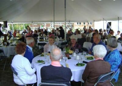 Tables under a white tent for an outdoor wedding
