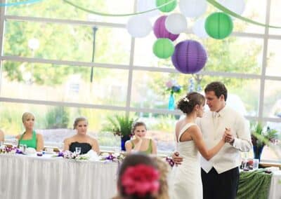 Bride and groom dance during an indoor reception