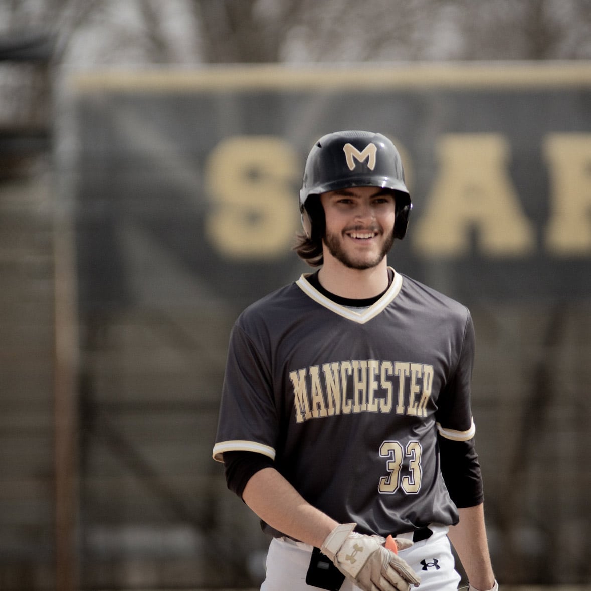 All-Smiles MU Baseball #33 is seen smiling on his way back to the dugout.