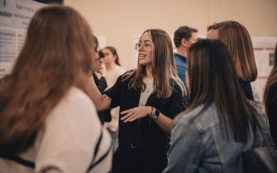 Student presents research poster at annual Student Symposium.