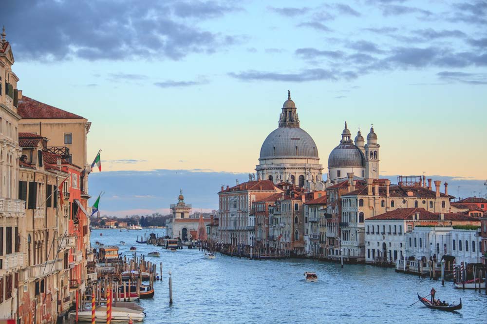 Travel to Northern Italy with Manchester University Alumni travel and excursions. Image features wide shot of Venice Italy overlooking the water.
